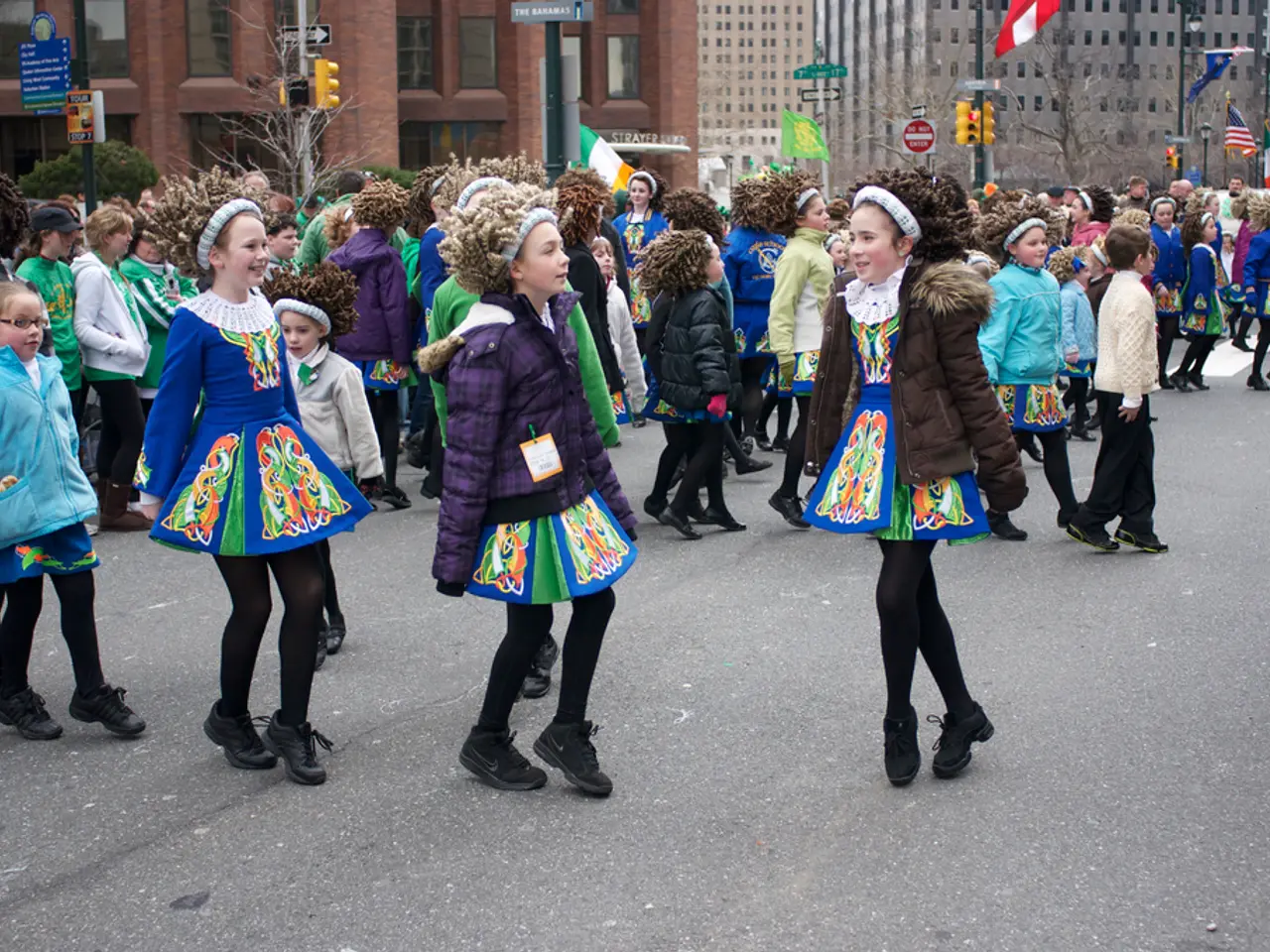 In this picture there is a group of girls wearing dress with jackets and sweaters dancing on the...
