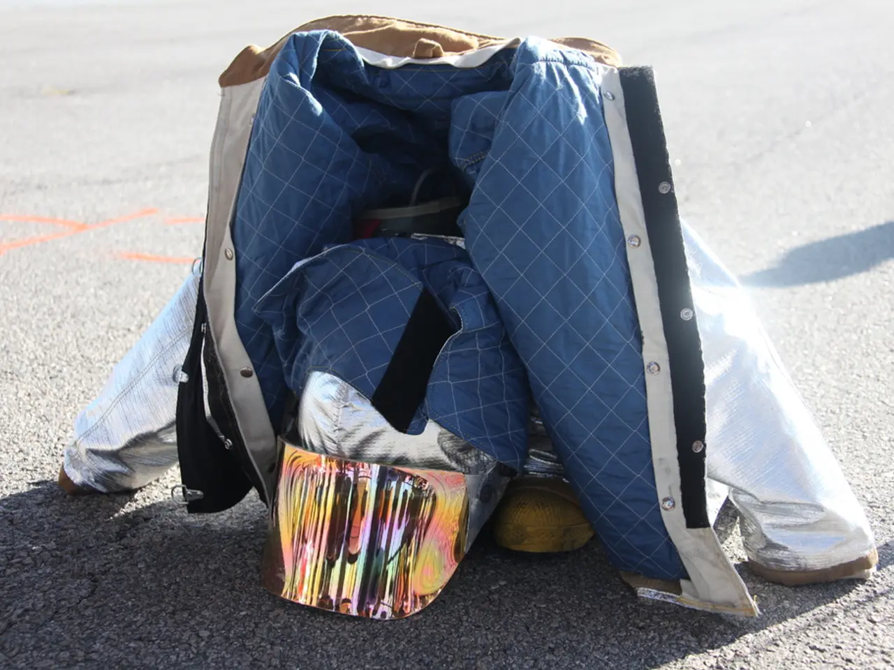 In this image there is a jacket and there are objects on the road.