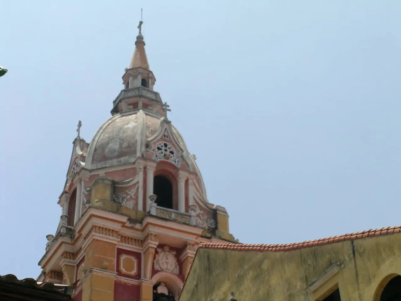In the foreground of this image, there are roofs of house and we can also see a dome of a building...