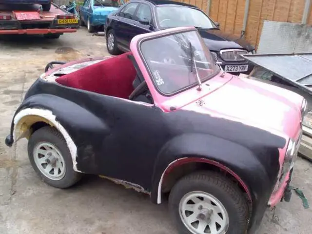 In this image there are many vehicles. This is a wall.