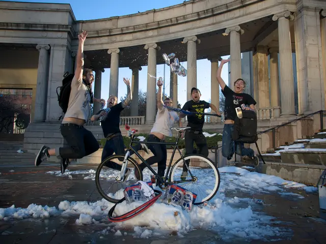 This image is clicked outside. There is a building in the middle. There is a bicycle, five people...