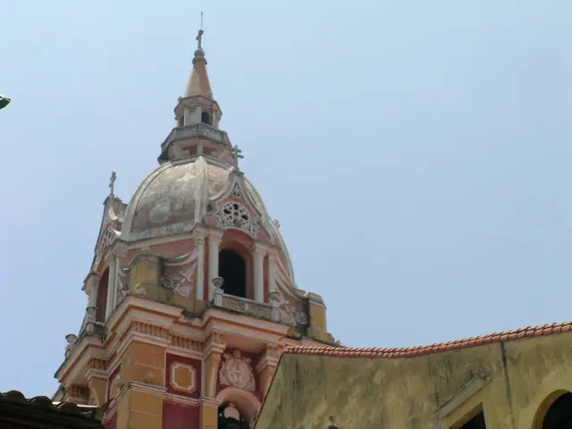 In the foreground of this image, there are roofs of house and we can also see a dome of a building...
