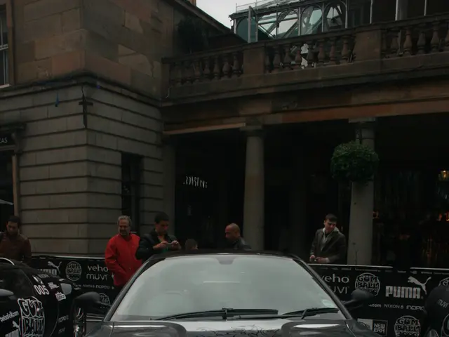 This picture is clicked outside. In the foreground we can see the cars parked on the pavement and...