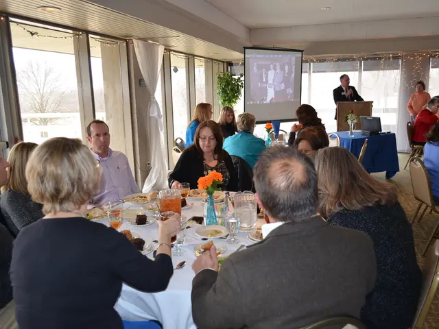 It looks like a a party where are lot of people sitting around the table and on the table there is...
