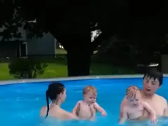 In this picture I can see there is a man and a woman swimming in the swimming pool and they are...